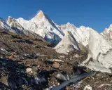 Lodowe formacje i skaliste zbocza na tle majestatycznych gór Karakorum.